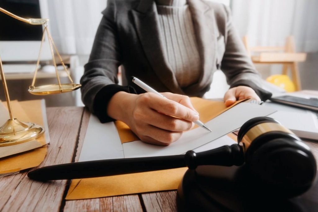 woman signing documents for divorce process